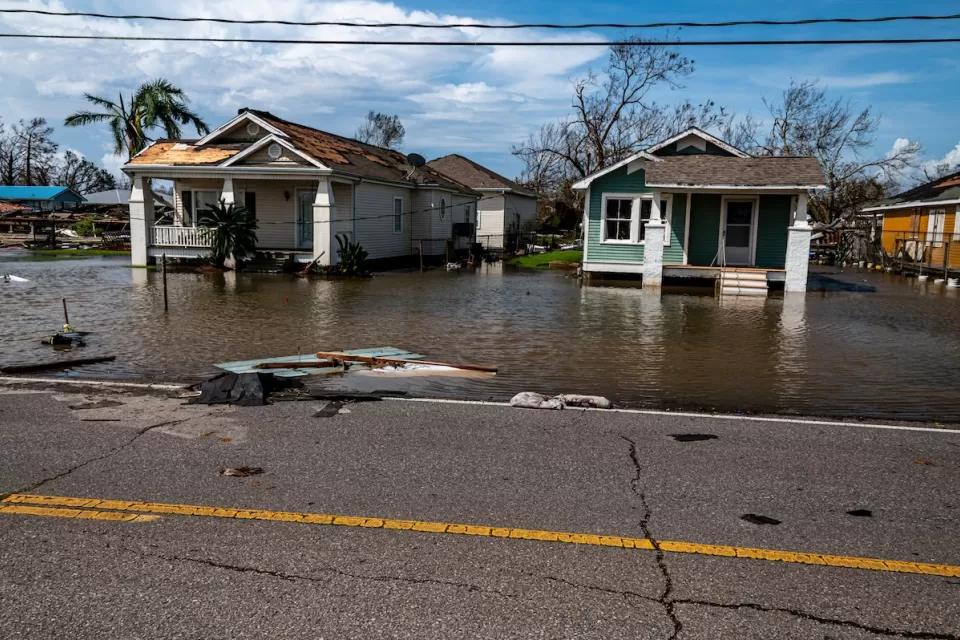 Two small wood homes with floodwaters in coastal Louisiana after Hurricane Ida.
